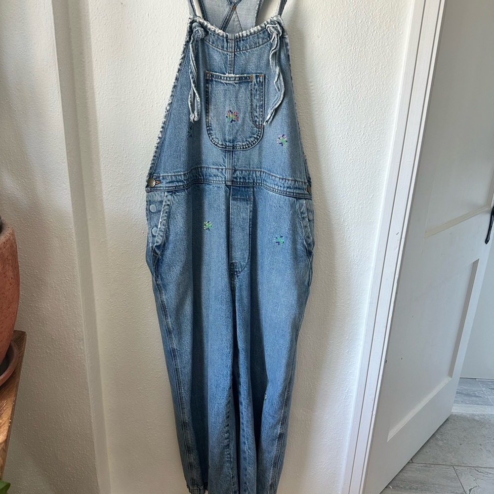 The GREAT. Light Wash Denim Overalls with Tiny Floral Embroidery
